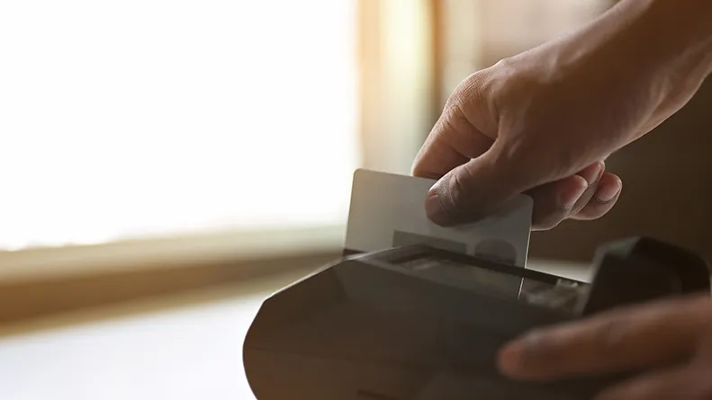 Person swiping payment card