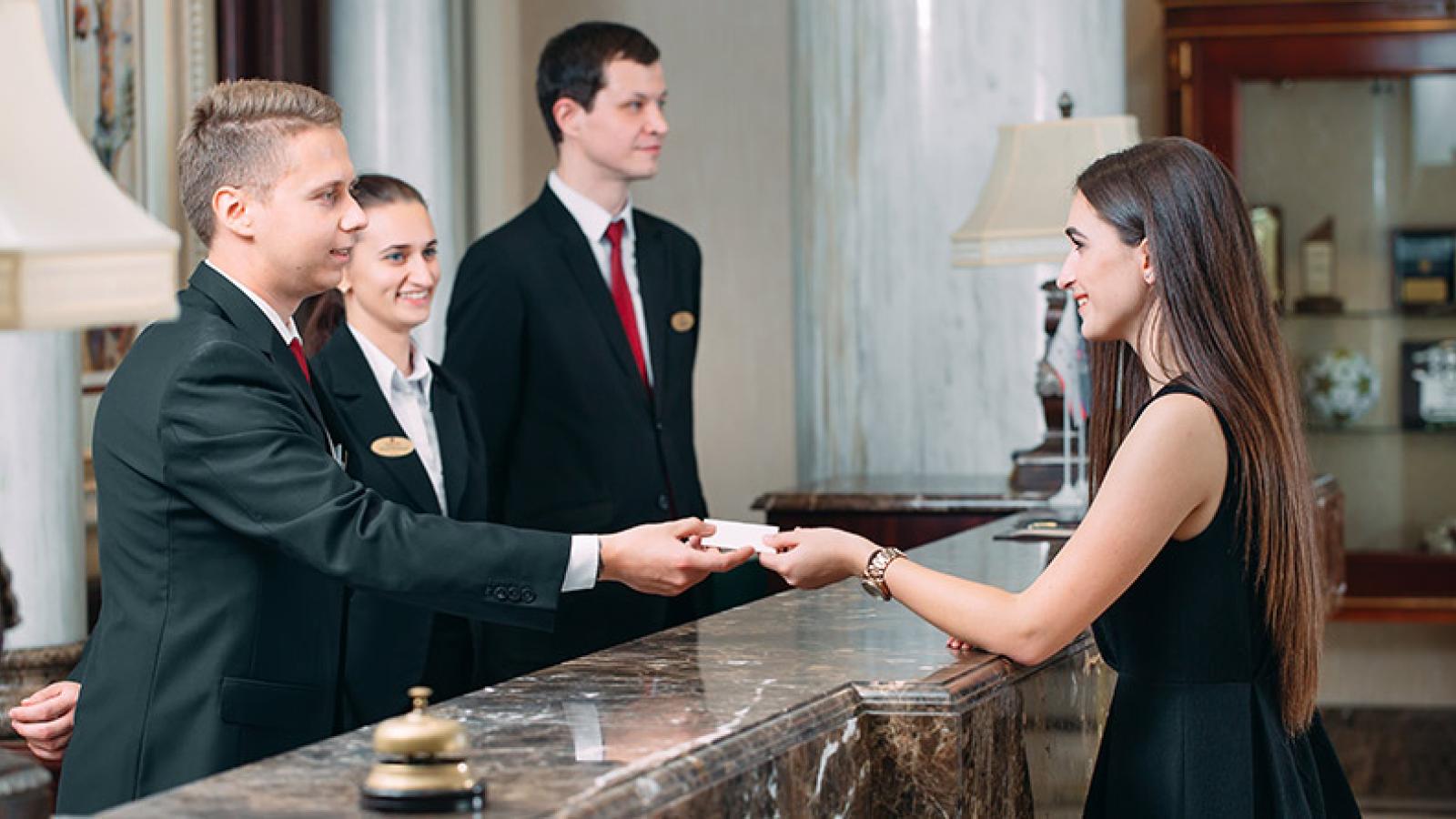 Receiving hotel key card at reception